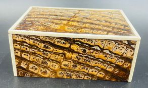 A vintage Fortnum and Mason of London cigarette box in a faux snakeskin effect