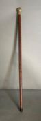 A walking cane in three sections with internal glass lined hip flask and compass