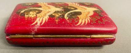 An ornate Russian snuff box in red