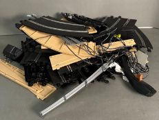 A quantity of Skalextric track and barriers along with two controlers