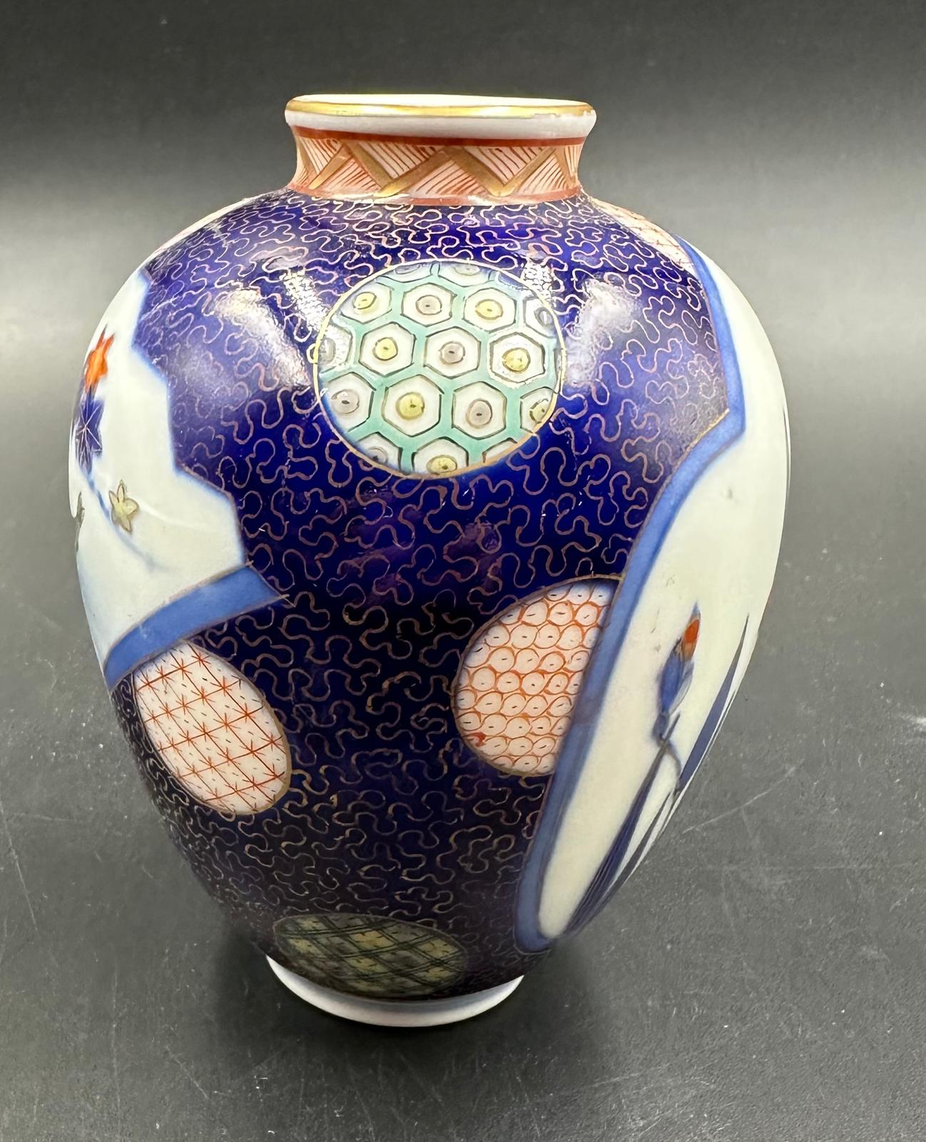A small Japanese vase in baluster form. Blue grounds and decorated with flowers and fish Height - Image 2 of 4
