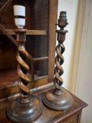 A pair of wooden twist candlesticks