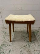 A Mid century stool with faux sheepskin seat