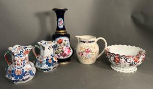 A selection of jugs, a bowl and a floral painted centre piece