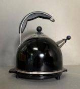 A black Aga kettle on cast iron stand