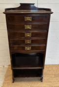 An Edwardian music cabinet comprising of five drawers, two shelves and a galleried top (H110cm W50cm