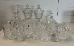 A selection of cut glass and crystal items to include brandy balloons, decanters and lidded vases