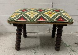 An arts and crafts footstool on bobbin legs with and aztec style upholstery