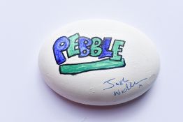 A Pebble hand painted by Comedian and Podcast Host Josh Widdicombe to raise funds for the