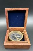 A vintage wooden cased brass compass, the box featuring a brass star inlay