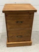A pine two door side cabinet, the deep drawers for files of other items (H78cm W53cm D46cm)