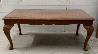 A carved walnut glass topped coffee table (H48cm W104cm D50cm)