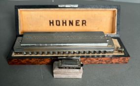 Two mouth organs, a Hohner 64 Chromonic and a Golden Curl miniatures