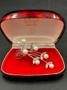 A pearl and silver brooch