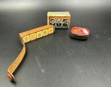 A selection of curios to include a WWII commemorative match box cover, a vintage HMV record needle