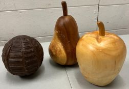 Three wooden fruit sculptures