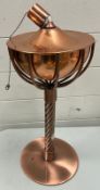 A copper bowl oil burning torch