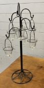 A tee light table stand with glass tear drop holders