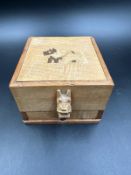 A vintage wooden Scottie dog cigarette dispenser