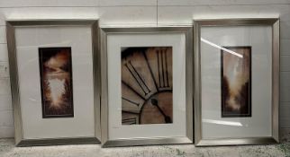 Three photographic prints of a clock and two sunsets 61cm x90cm