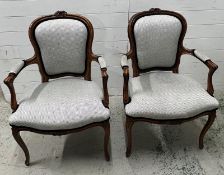 A pair of Louis style open arm chairs