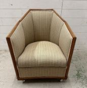 An oak framed Art Deco lounge chair in a beige upholstery