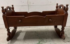 A 19th Century mahogany rocking cradle with carved stars to ends