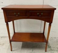 A two drawer veneered side table with shelf under and on turned legs (H76cm W66cm D32cm)