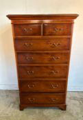 A mahogany veneered tall boy with two short drawers over five long (H133cm W76cm D49cm)