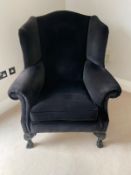 A blue upholstered wing back arm chair on cabriole legs with claw and ball feet by Duresta