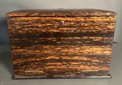 An Edwardian Coromandel stationary box, the fall front opening to a fitted interior comprising of