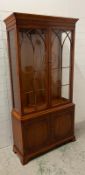 A Bradley display cabinet with cupboard under (H197cm W102cm D34cm)
