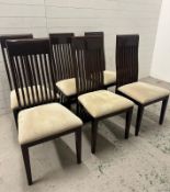 A set of six contemporary stick back dining chairs upholstered in beige