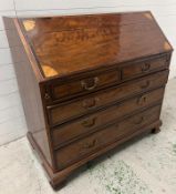 A mahogany inlaid bureau opening to pigeon holes and drawers (H110cm W110cm D59cm)
