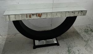 A contemporary mirrored console table