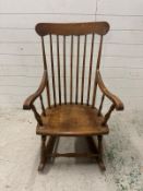 A vintage oak spindle back rocking chair