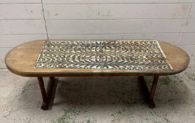 A Mid Century glass topped coffee table with a tribal art underlay to top (H37cm W130cm D48cm)