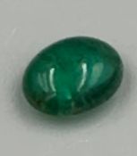 An emerald cabochon stone 8mm long