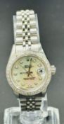 A Rolex Oyster Perpetual watch, round white mother of peral dial, diamond dot indices to diamond set