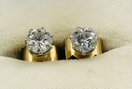 A Pair of brilliant cut diamond stud earrings mounted in yellow gold. 6.06 x 6.33 x 5.00 mm