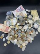 A selection of worldwide coins and several UK crowns.
