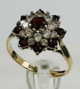 A 9ct gold garnet and cz ring size O and approximate weight 2.7g