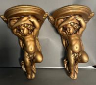 A pair of gilt plaster cherub wall brackets