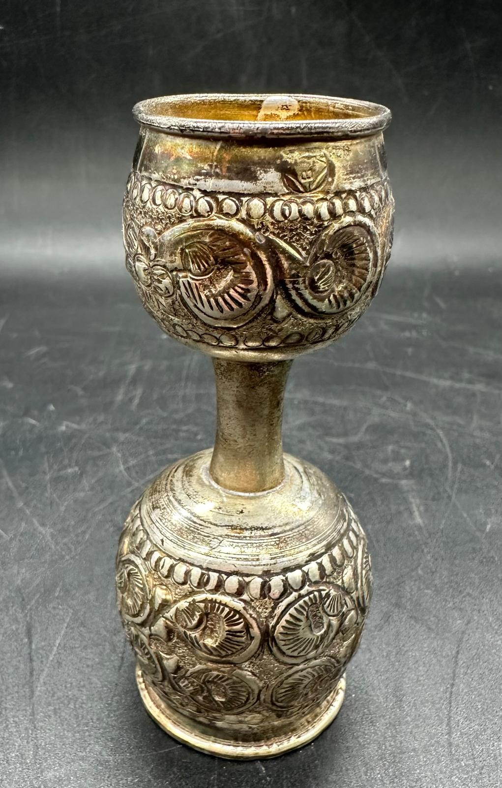 A silver Indian drinks measure, 10cm H