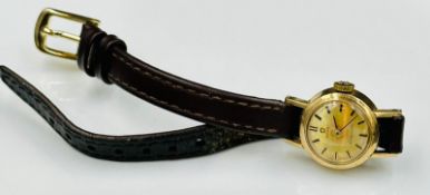 A Ladies Omega Ladymatic on brown leather strap.