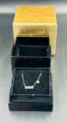 An 18ct White Gold Diamond and Emerald Anouskha Necklace consisting of four cushion shape emeralds