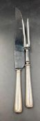 A silver handled carving set of knive and fork by William Yates Ltd and hallmarked for Sheffield.
