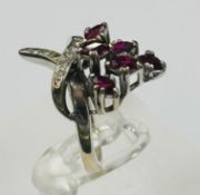 A ruby and diamond crossover ring on white gold setting approximate size L