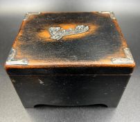 A wooden cigarette box with hallmarked silver fitments.