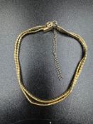 An 18ct yellow gold two strand bracelet with an approximate weight of 13.8g, marked 750